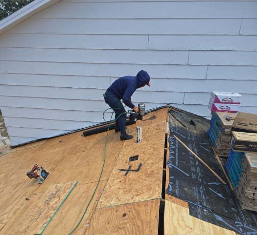 Roofing worker actively repairing a residential roof in Apopka, Florida