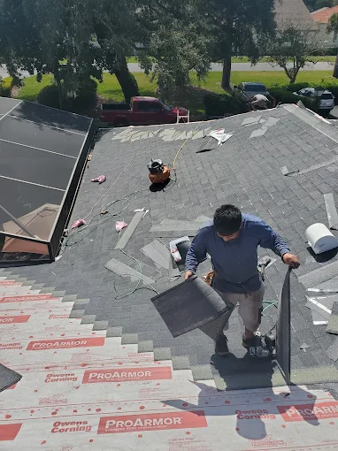 Roofing contractor repairing a residential roof in Orlando, Florida.
